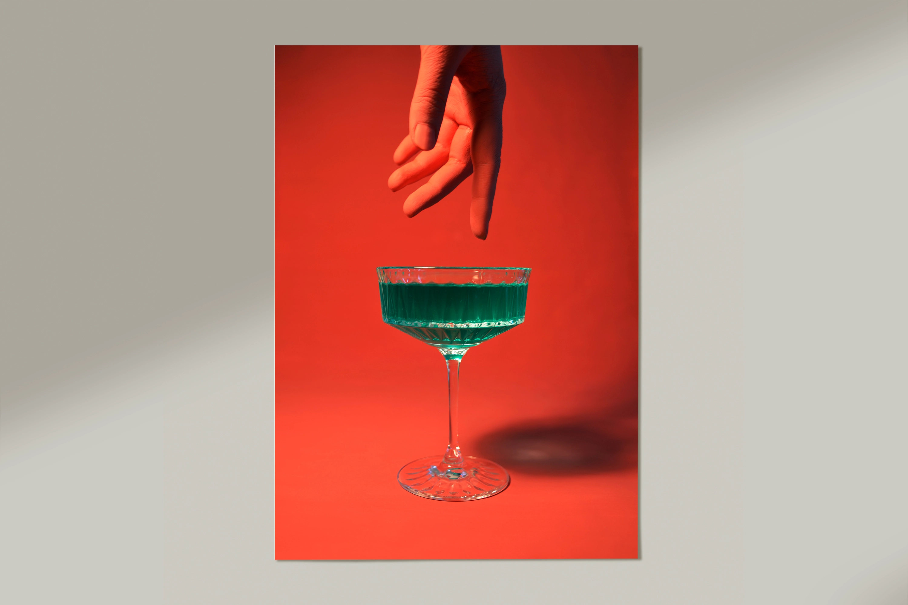 green cocktail on red background